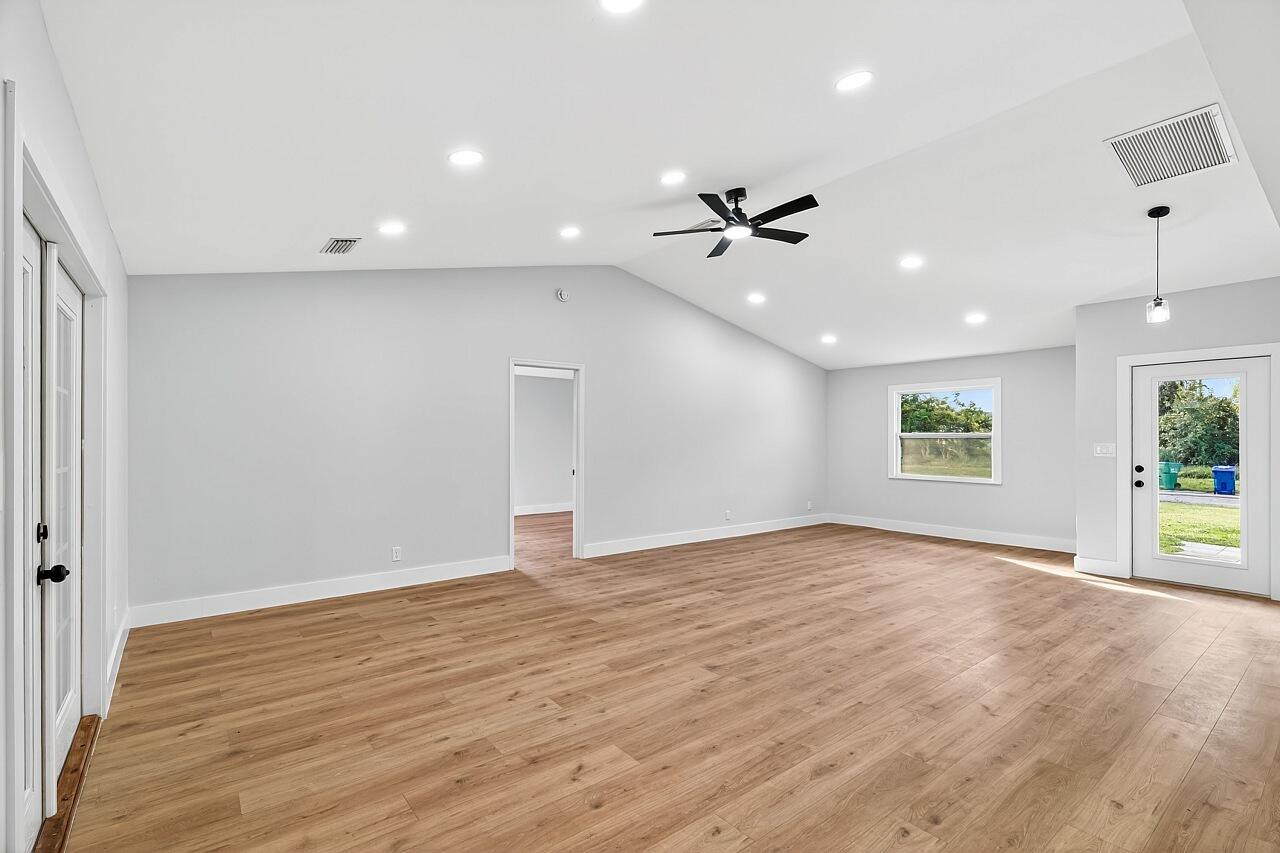 117 High Court Sebastian, FL 32958 - Photo 19 of 54 an empty room with wooden floor and a ceiling fan