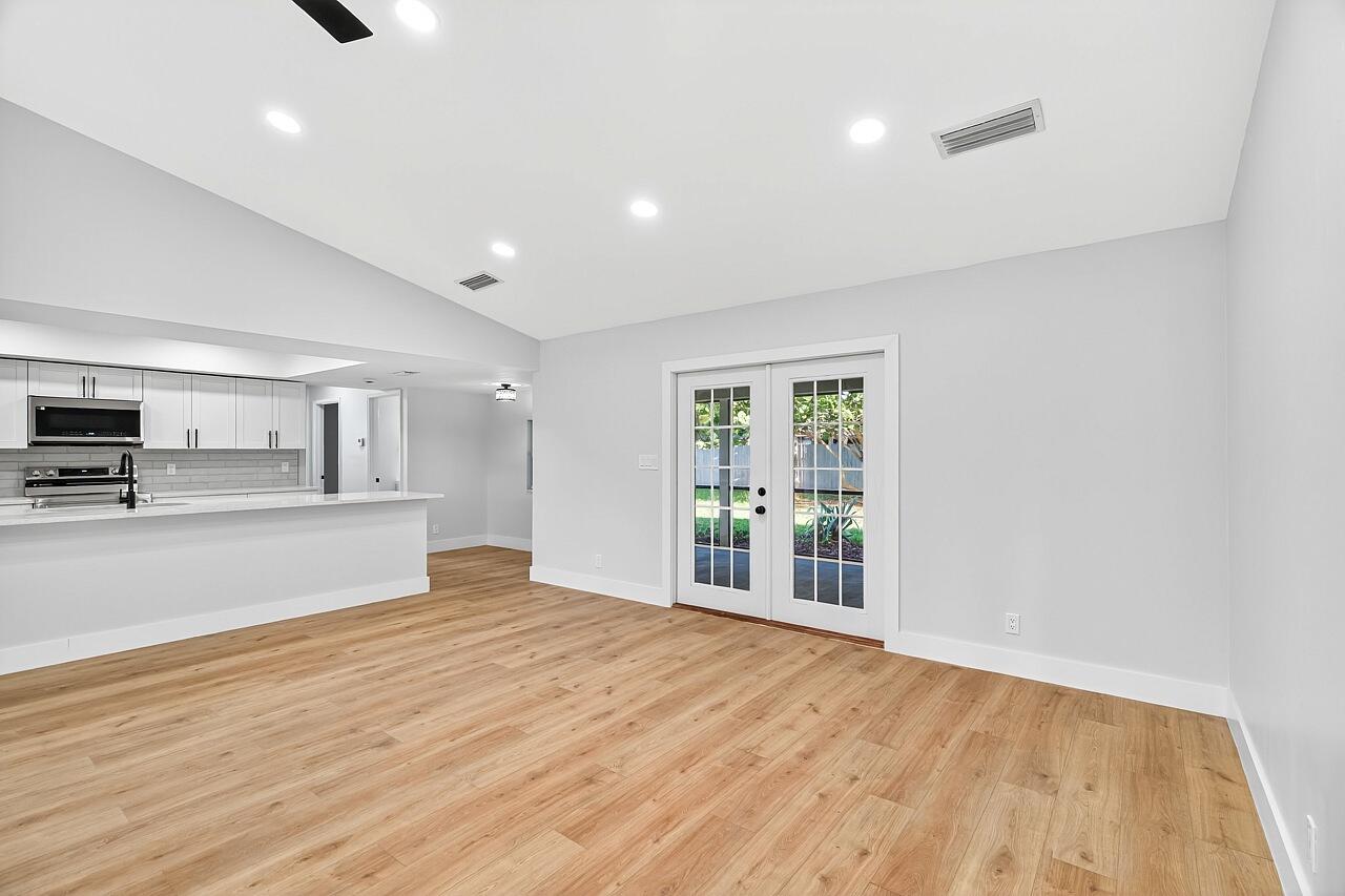 117 High Court Sebastian, FL 32958 - Photo 24 of 54 a view of kitchen and empty room with wooden floor