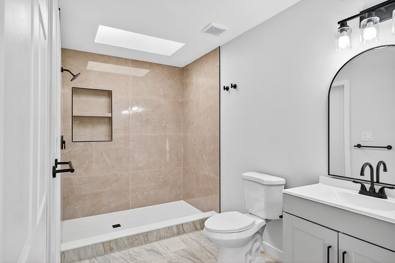 117 High Court Sebastian, FL 32958 - Photo 32 of 54 a bathroom with a sink a toilet and shower