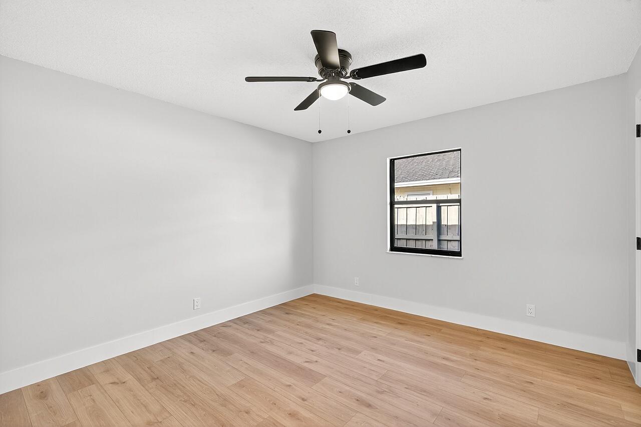 117 High Court Sebastian, FL 32958 - Photo 35 of 54 an empty room with wooden floor ceiling fan and windows