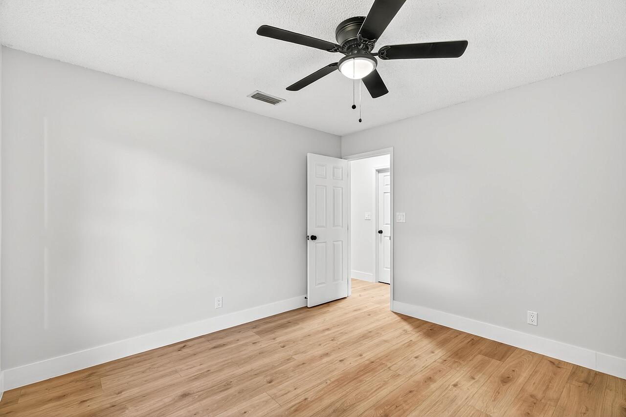 117 High Court Sebastian, FL 32958 - Photo 37 of 54 an empty room with wooden floor and ceiling fan
