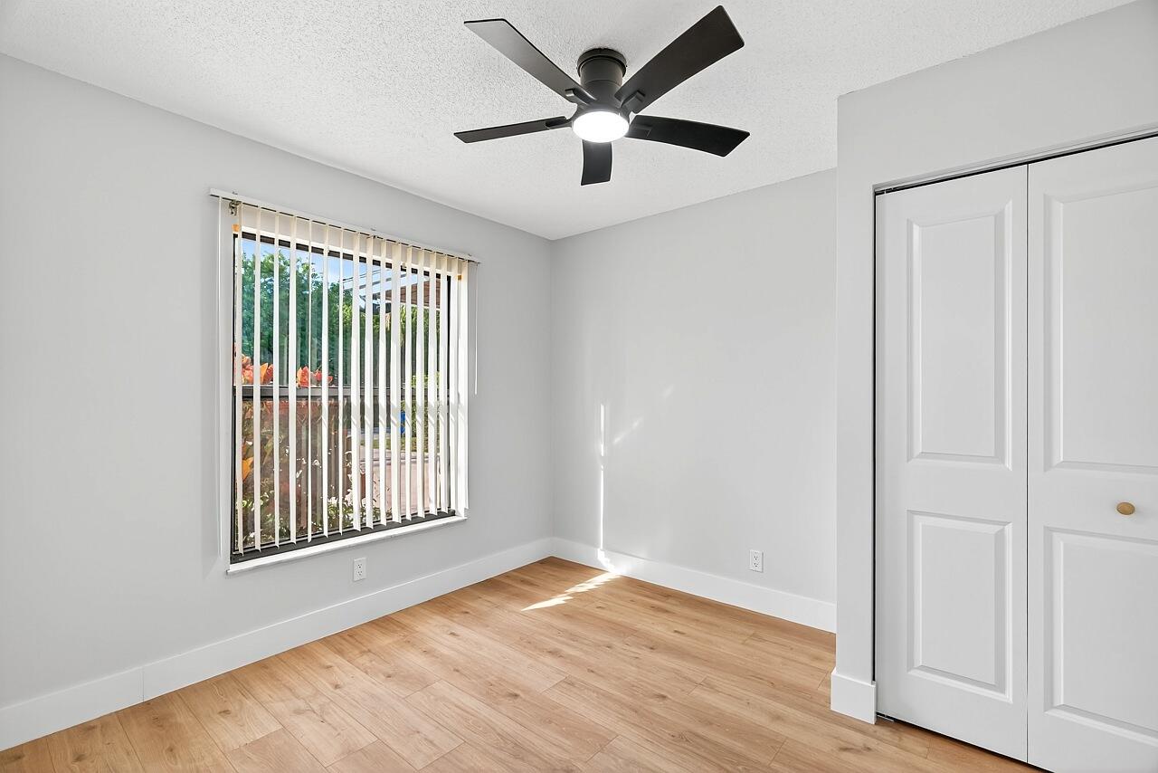 117 High Court Sebastian, FL 32958 - Photo 40 of 54 a view of an empty room with a window and wooden floor