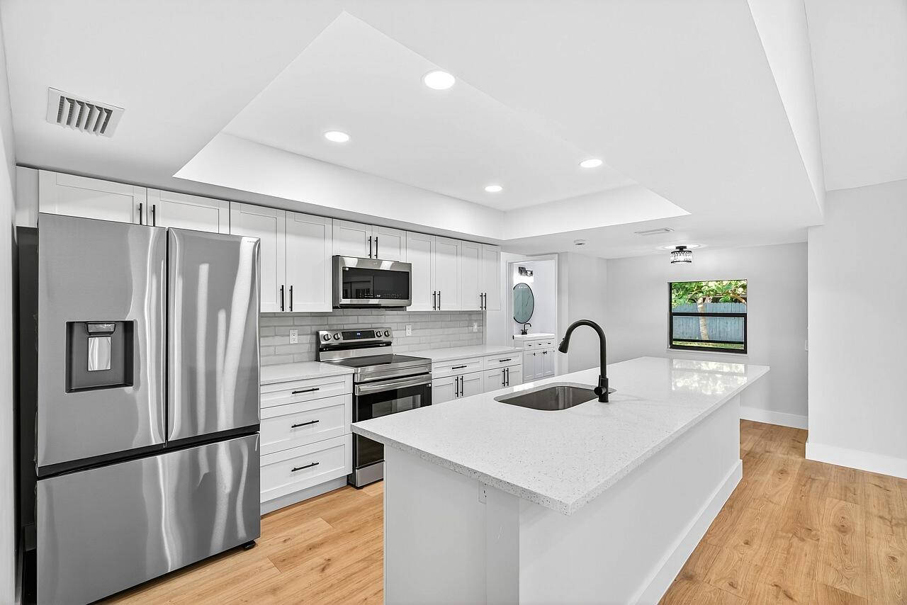 117 High Court Sebastian, FL 32958 - Photo 4 of 54 a kitchen with kitchen island a refrigerator stove and sink
