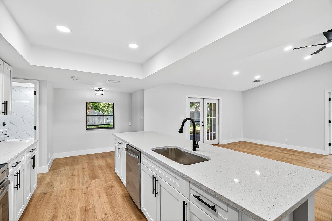 117 High Court Sebastian, FL 32958 - Photo 7 of 54 a kitchen with a sink a counter space and a view of living room