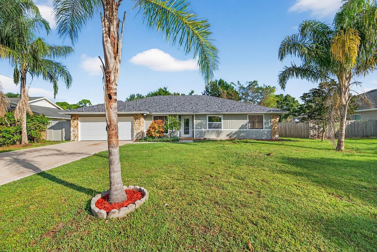 117 High Court Sebastian, FL 32958 - Photo 10 of 54 a front view of a house with a yard and palm trees