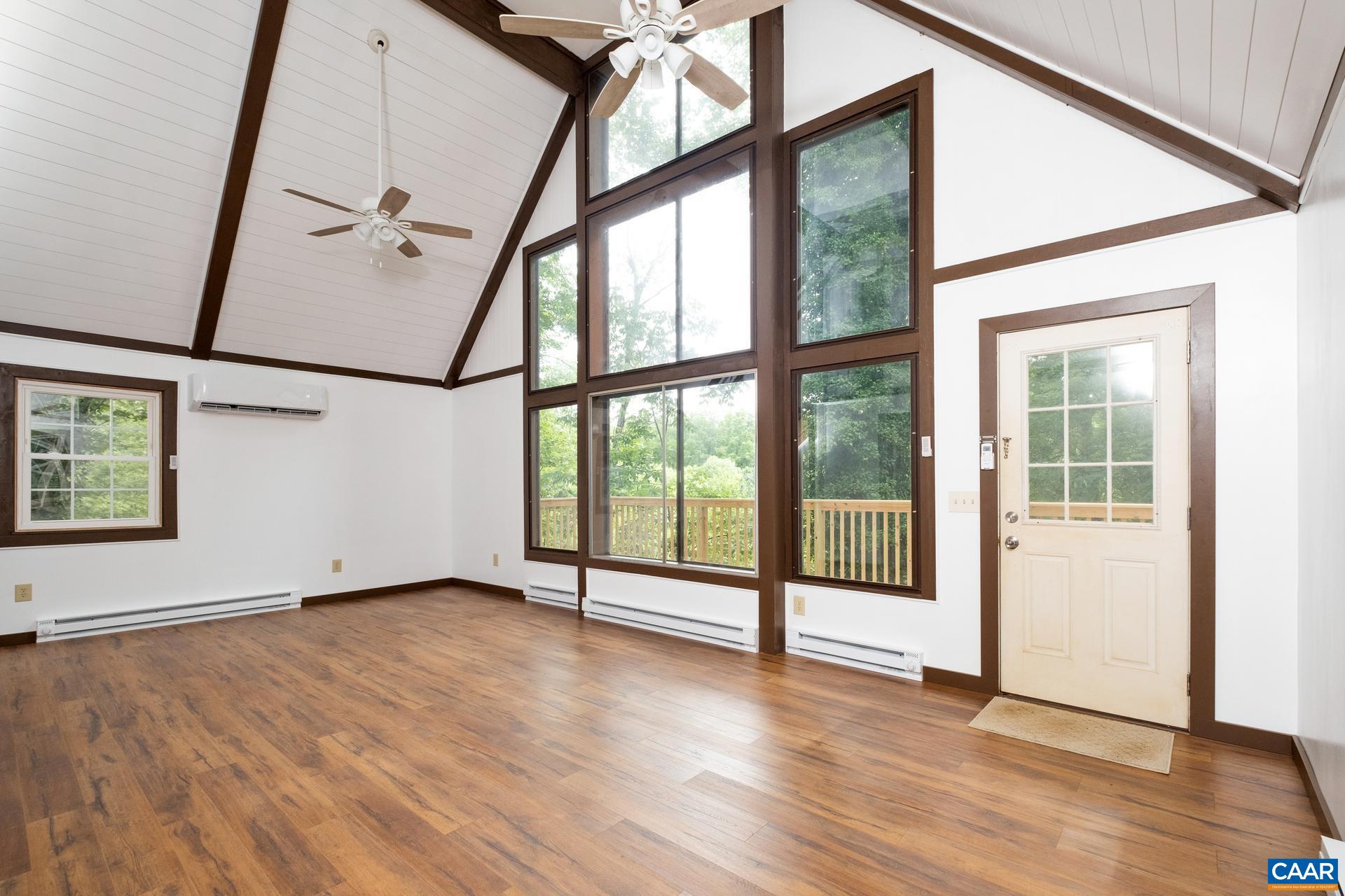 187 Logtrac Road Stanardsville, VA 22973 - Photo 12 of 19 an empty room with wooden floor and door