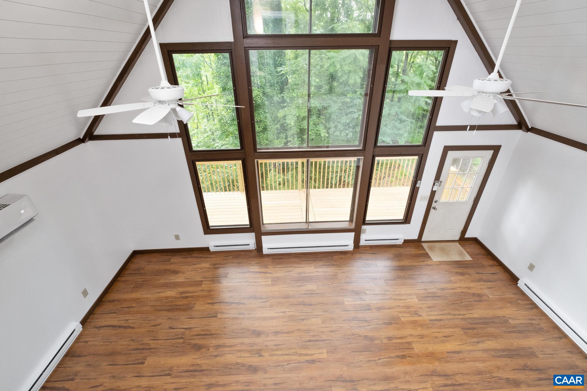 187 Logtrac Road Stanardsville, VA 22973 - Photo 14 of 19 a view of an empty room with wooden floor and a window