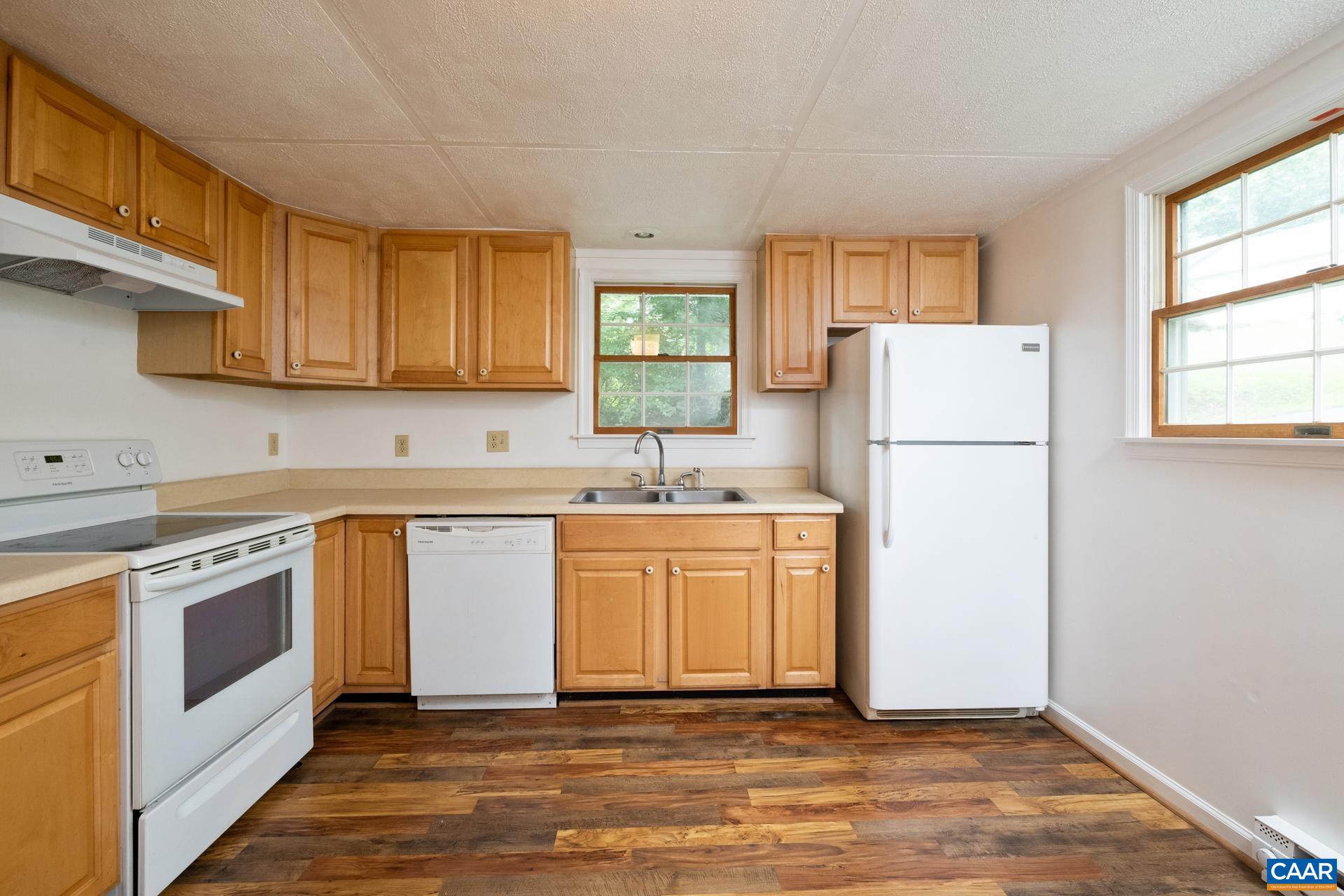 187 Logtrac Road Stanardsville, VA 22973 - Photo 6 of 19 a kitchen with a refrigerator sink stove and cabinets
