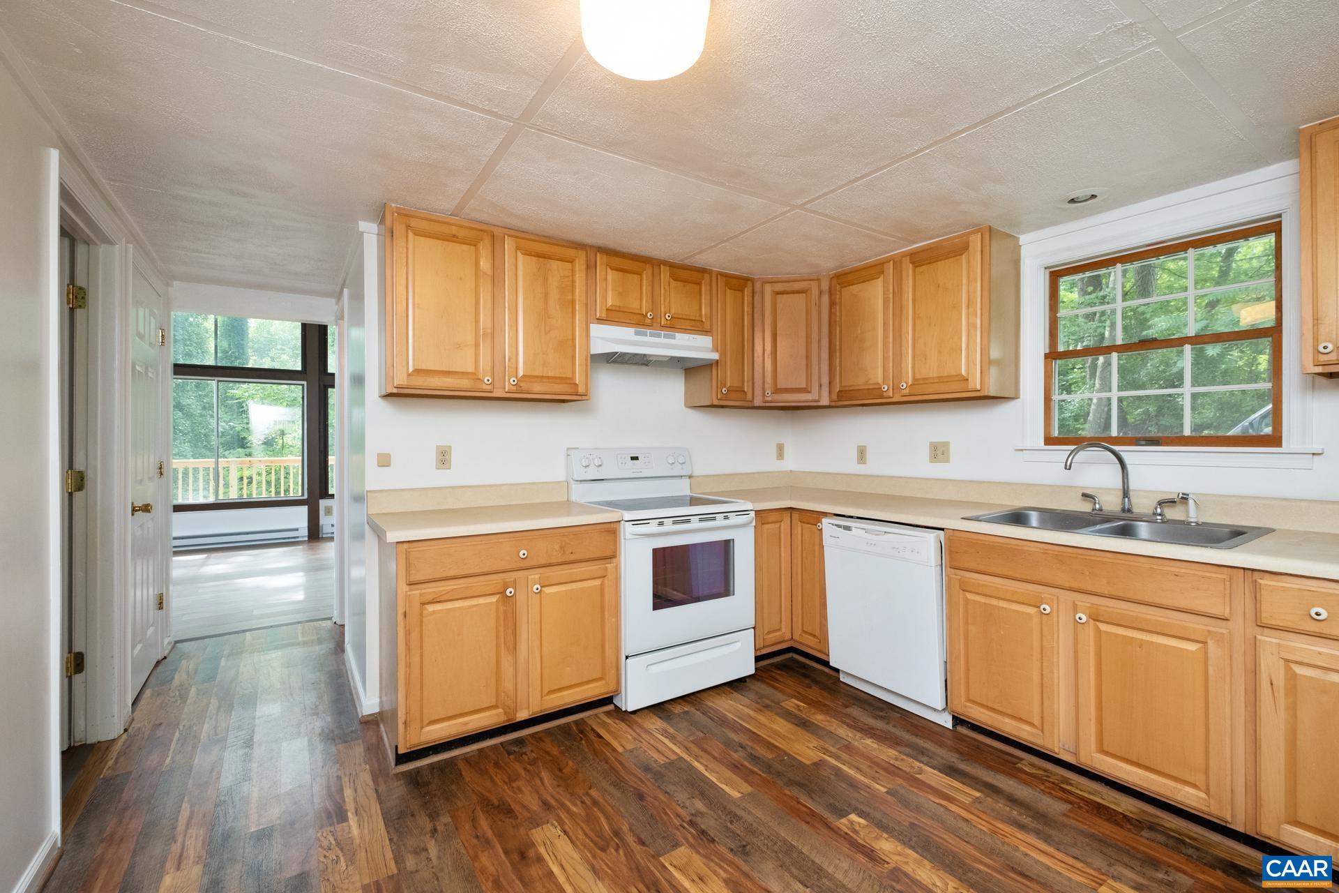 187 Logtrac Road Stanardsville, VA 22973 - Photo 7 of 19 a kitchen with stainless steel appliances granite countertop wooden floors a stove a sink and a window