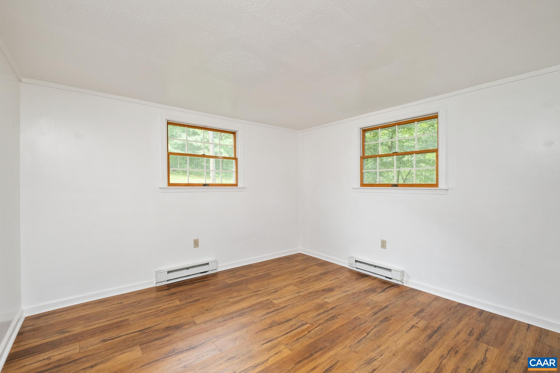 187 Logtrac Road Stanardsville, VA 22973 - Photo 9 of 19 an empty room with wooden floor and window
