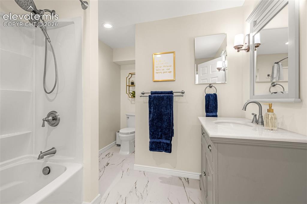 9127 Oakmont Road Peyton, CO 80831 - Photo 35 of 49 a bathroom with a tub sink toilet and shower