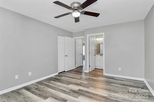 a view of a livingroom with a ceiling fan and window