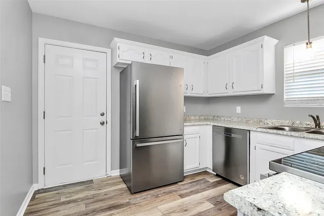 a kitchen with granite countertop cabinets and steel stainless steel appliances