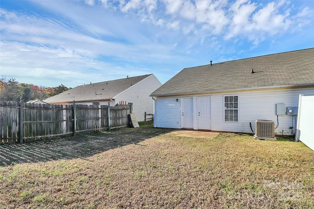 a view of a house with a backyard