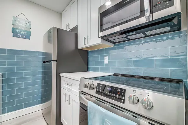 a stove top oven sitting inside of a kitchen