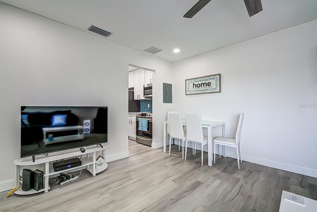 161 Medallion Boulevard, Unit E Madeira Beach, FL 33708 - Photo 16 of 19 a living room with furniture and a flat screen tv