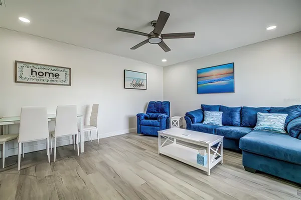 a living room with furniture and a wooden floor
