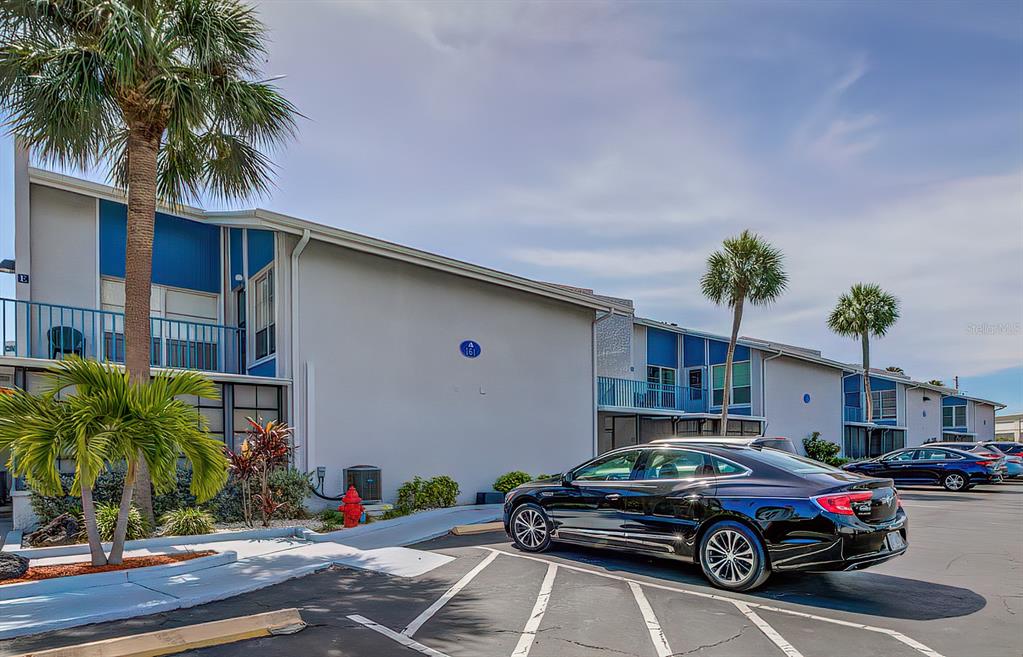 161 Medallion Boulevard, Unit E Madeira Beach, FL 33708 - Photo 19 of 19 a front view of a house with parking space