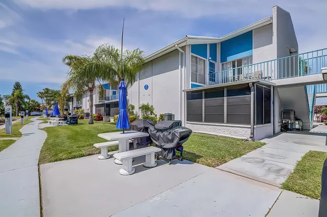 a view of a house with backyard sitting area and garden