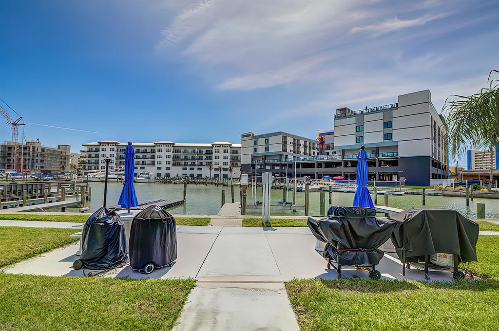 161 Medallion Boulevard, Unit E Madeira Beach, FL 33708 - Photo 4 of 19 a view of a lake with a table and chairs