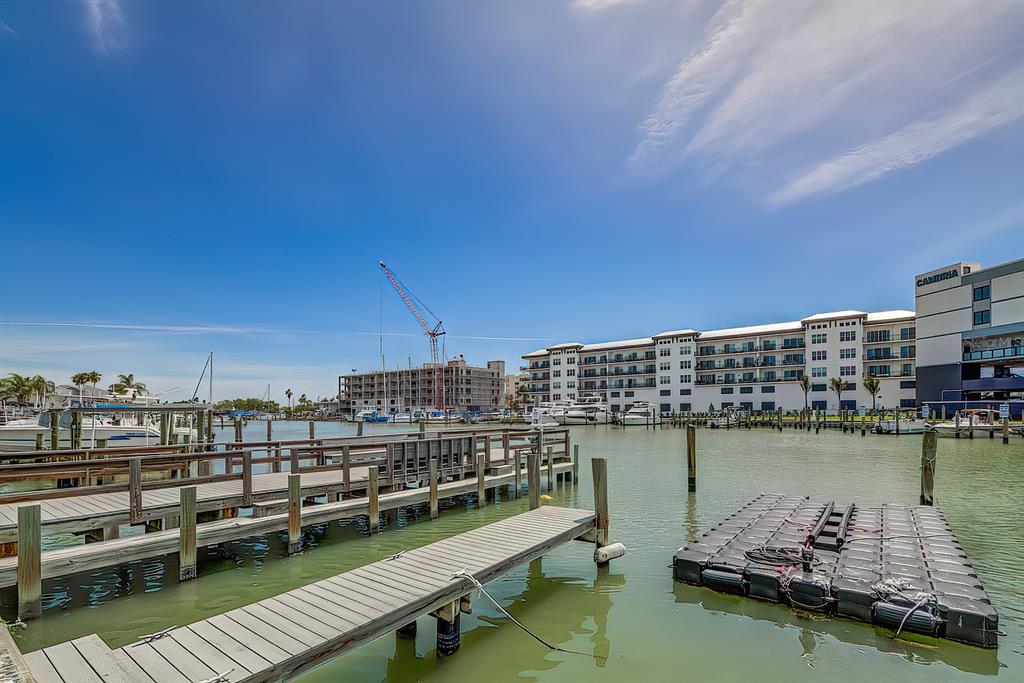161 Medallion Boulevard, Unit E Madeira Beach, FL 33708 - Photo 5 of 19 a view of a lake with tall buildings