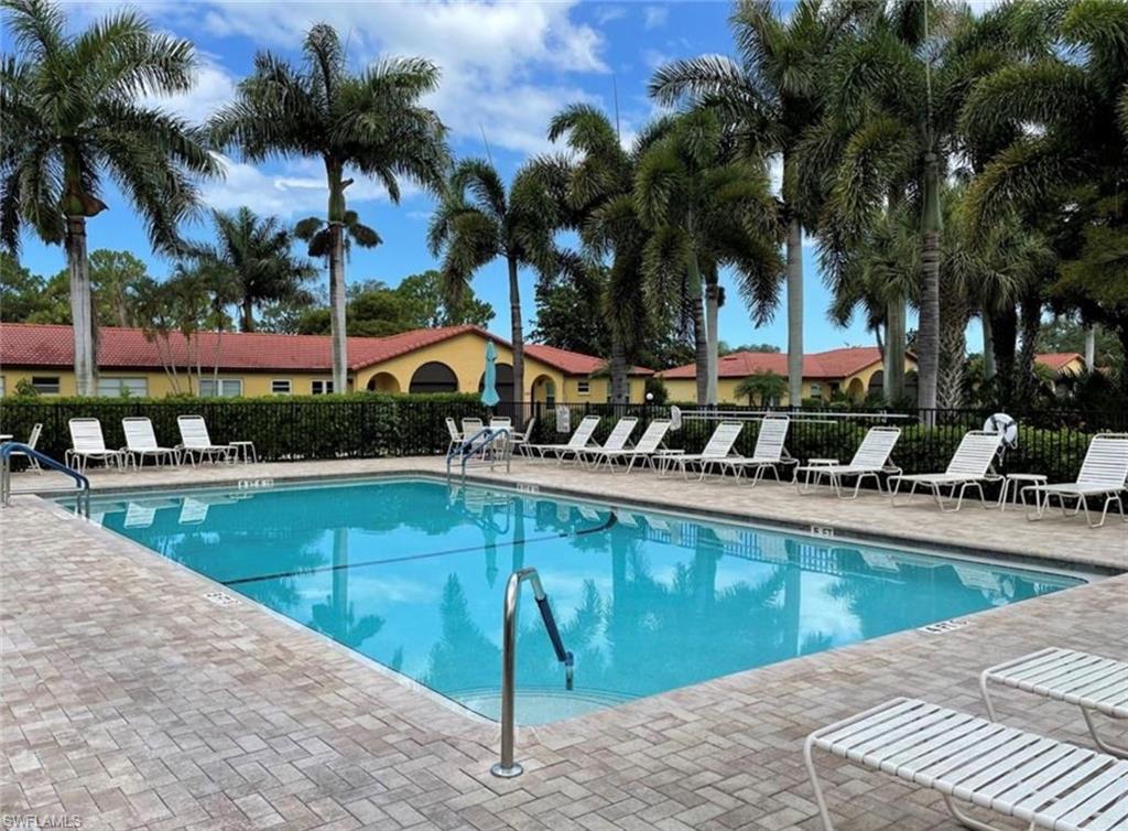 1085 Forest Lakes Drive, Unit 8106 Naples, FL 34105 - Photo 1 of 27 a view of a swimming pool with a patio