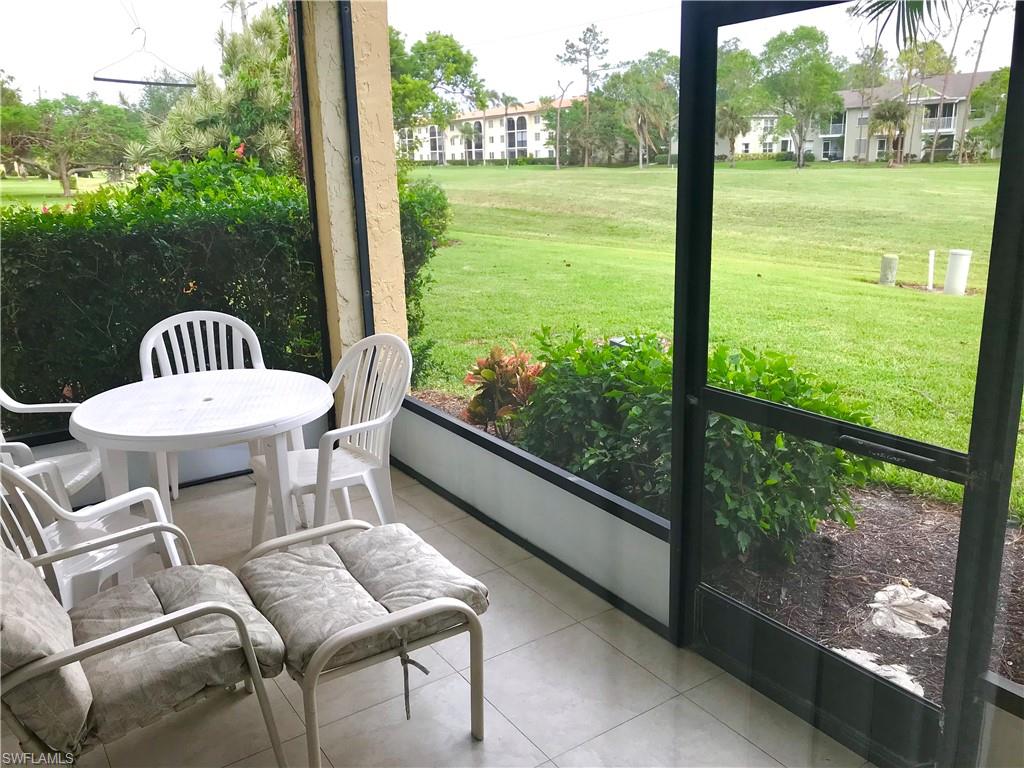 1085 Forest Lakes Drive, Unit 8106 Naples, FL 34105 - Photo 11 of 27 a view of a room with a table and chairs