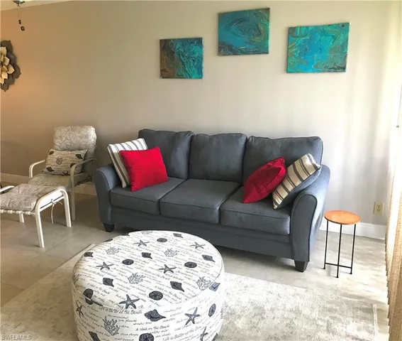 a living room with furniture and a rug