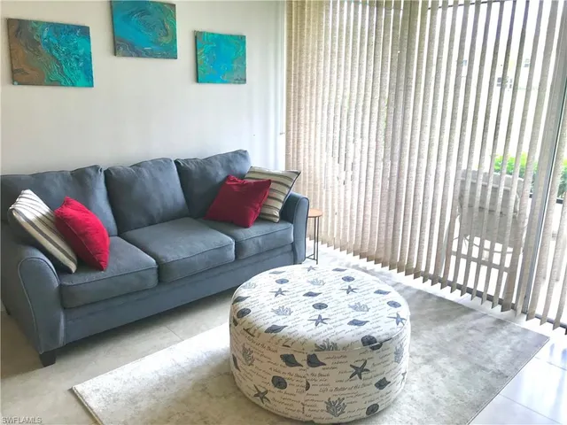 a living room with furniture and a pool