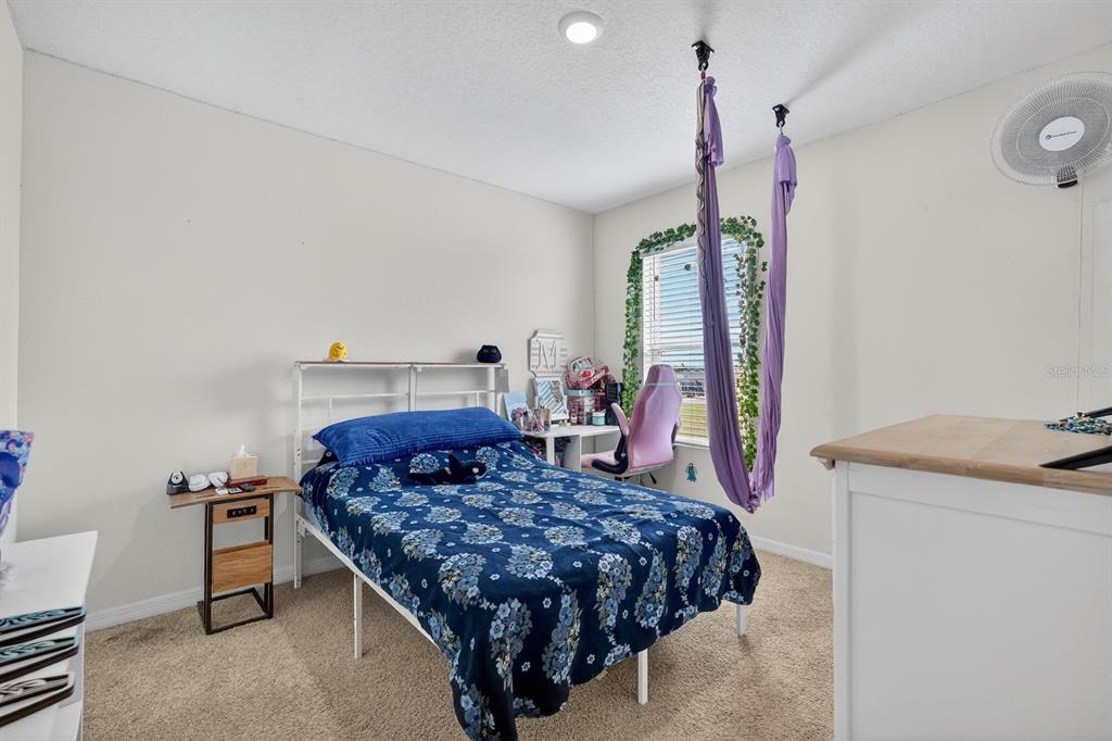 1809 Myrtlebrooke Drive Edgewater, FL 32141 - Photo 25 of 58 a bed room with a bed window and a chair