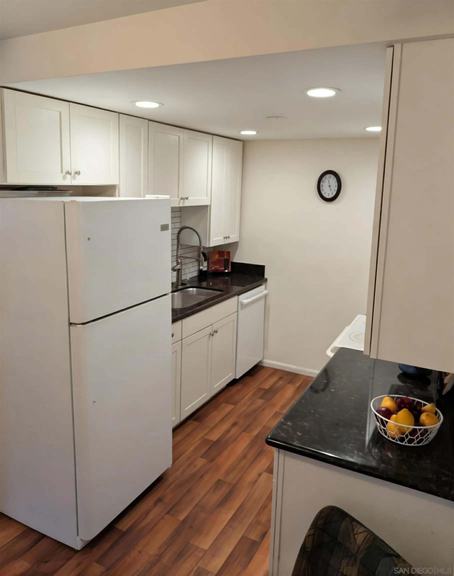 12643 Robison Boulevard, Unit 213 Poway, CA 92064 - Photo 5 of 5 a kitchen with granite countertop a refrigerator a stove and a sink