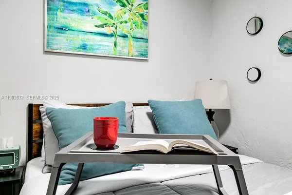 a bedroom with a bed and a large window