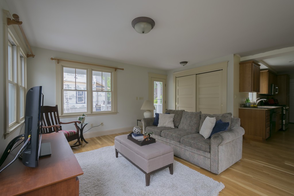4 Reed Street Lexington, MA 02421 - Photo 16 of 30 a living room with furniture flat screen tv and a large window