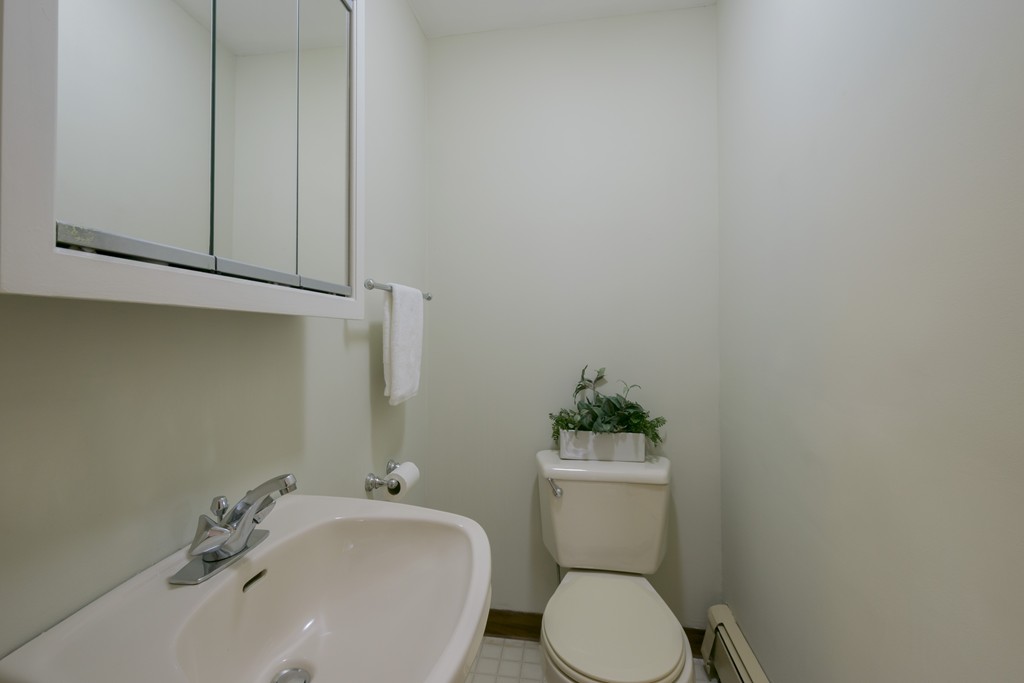 4 Reed Street Lexington, MA 02421 - Photo 18 of 30 a white toilet sitting next to a bathroom sink