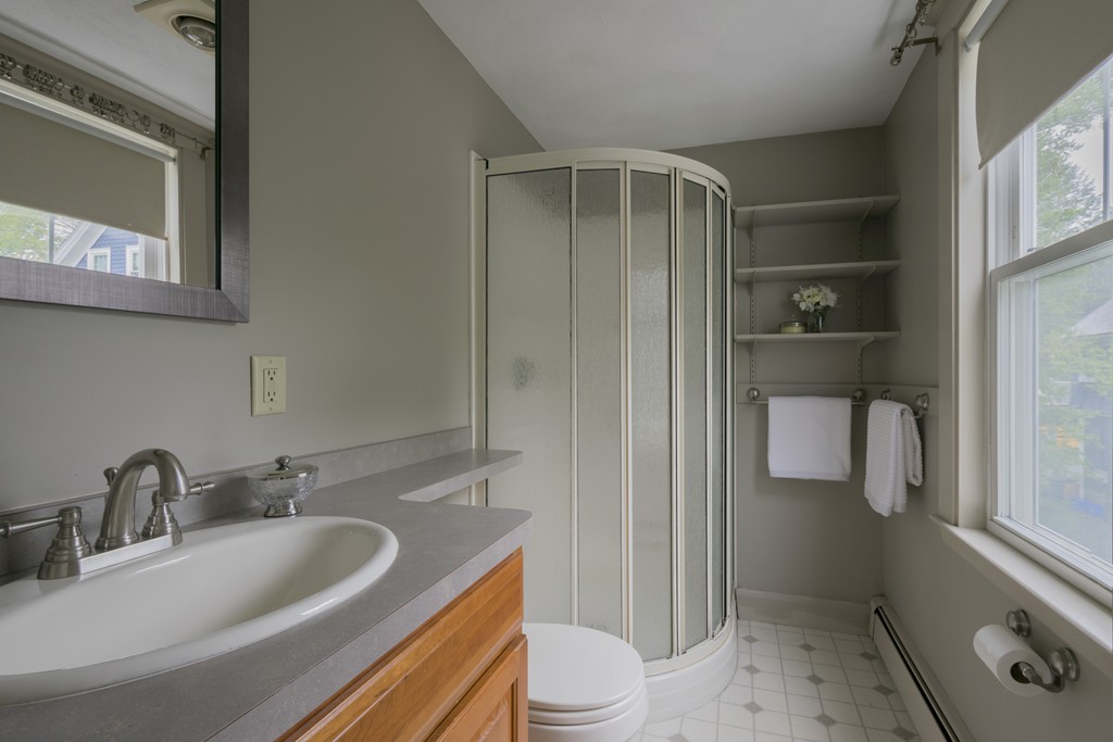 4 Reed Street Lexington, MA 02421 - Photo 23 of 30 a bathroom with a sink a toilet and shower