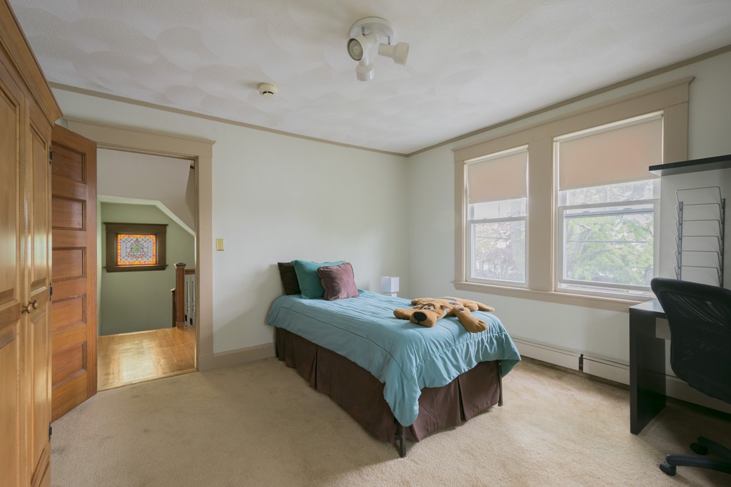 4 Reed Street Lexington, MA 02421 - Photo 25 of 30 a bedroom with a bed and a window