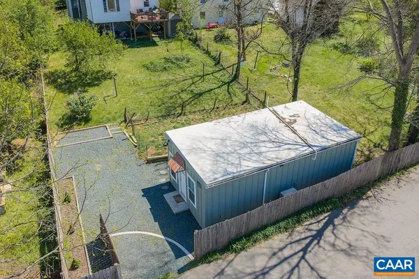 a view of a backyard both side of the house