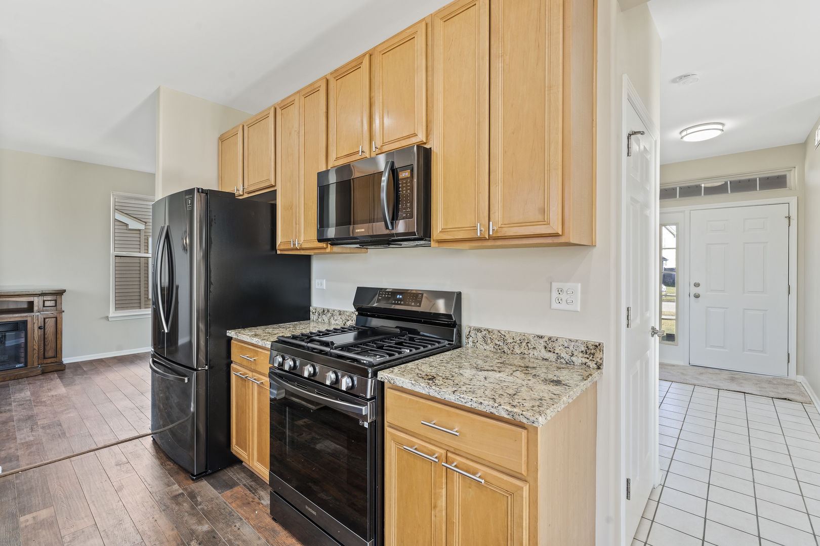 32804 Bending Creek Road Lakemoor, IL 60051 - Photo 11 of 42 a kitchen with stainless steel appliances granite countertop a stove a refrigerator and a microwave