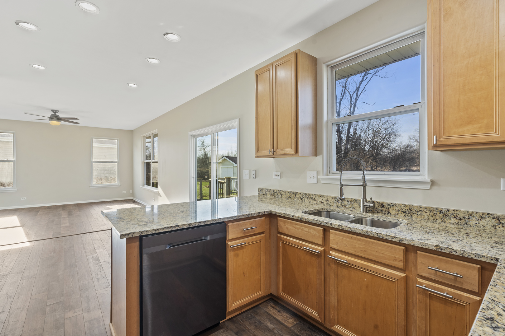 32804 Bending Creek Road Lakemoor, IL 60051 - Photo 13 of 42 a kitchen with granite countertop kitchen island a sink appliances and a window