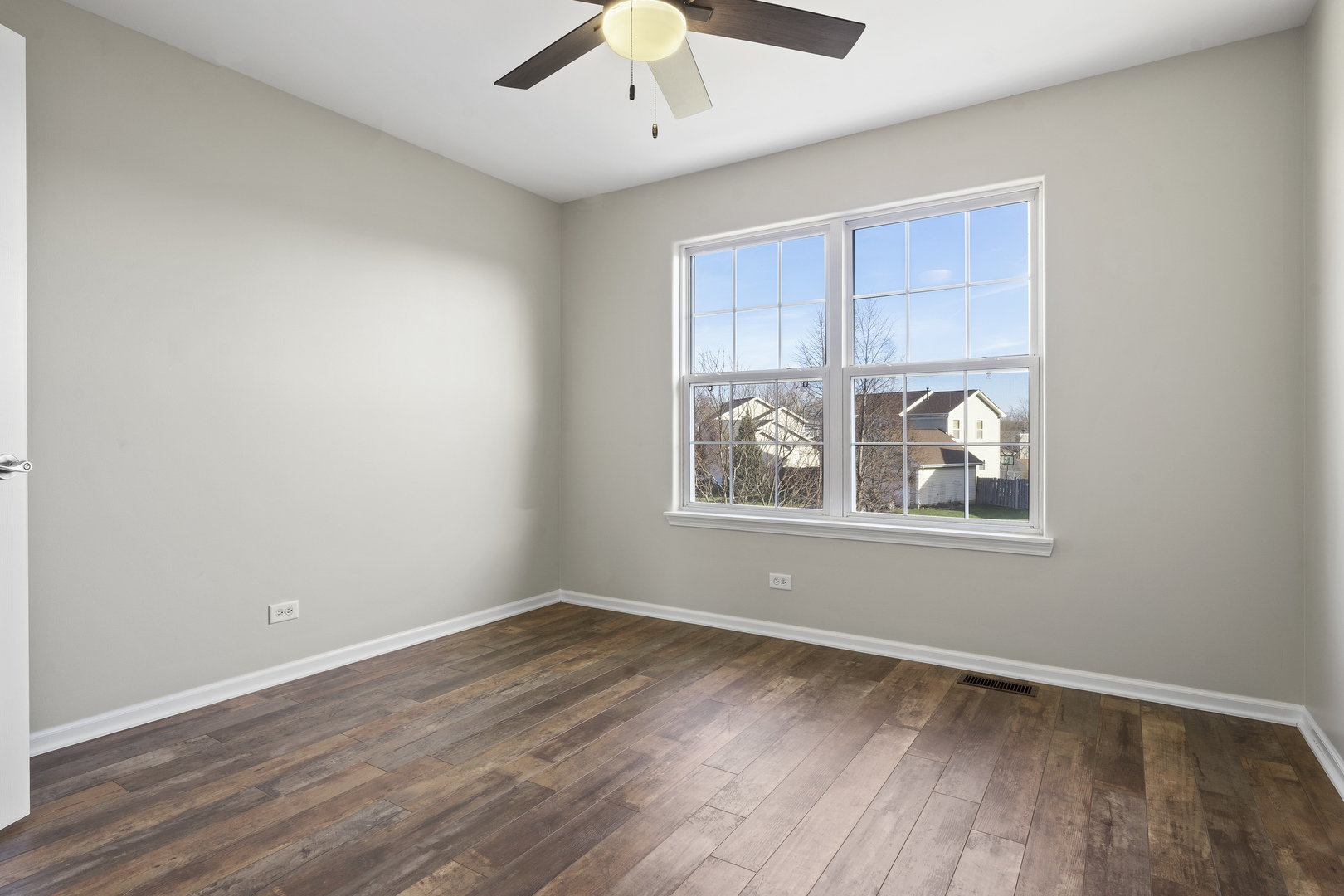 32804 Bending Creek Road Lakemoor, IL 60051 - Photo 19 of 42 an empty room with wooden floor and windows