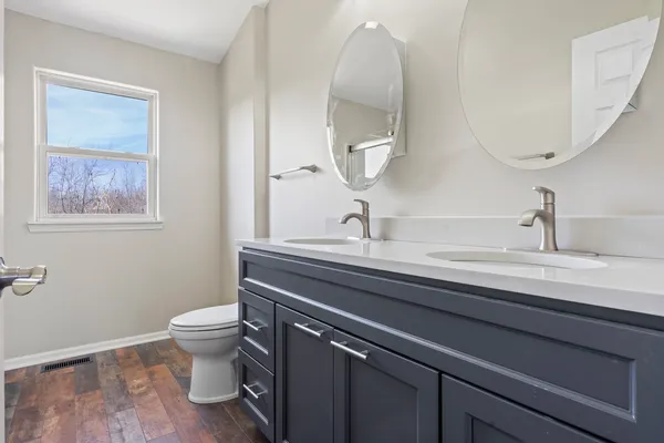 a bathroom with a toilet sink and mirror