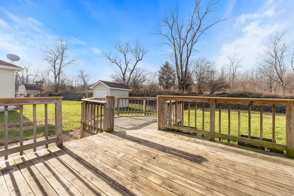 a view of a house with wooden floor next to a yard