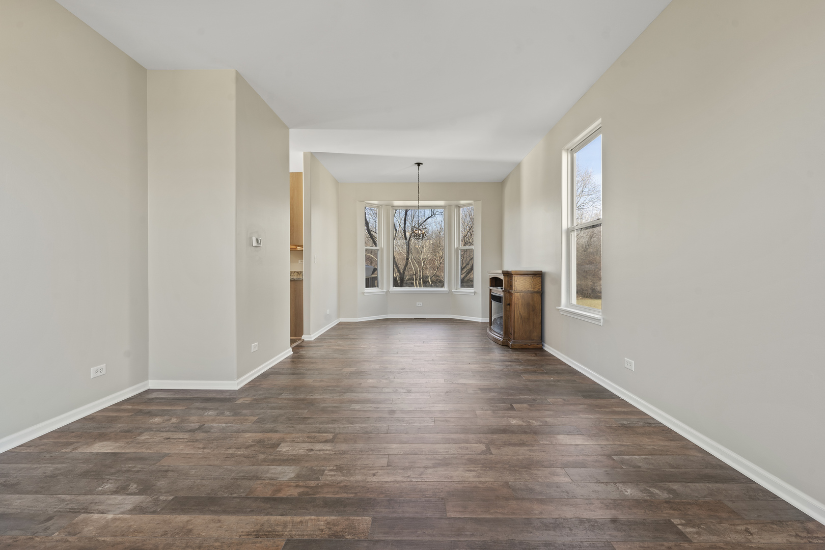 32804 Bending Creek Road Lakemoor, IL 60051 - Photo 6 of 42 a view of a livingroom with wooden floor and a window