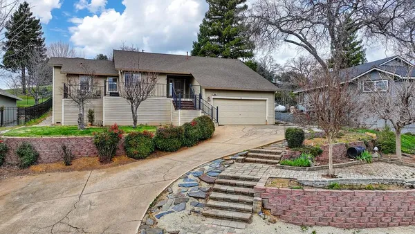 a front view of a house with garden