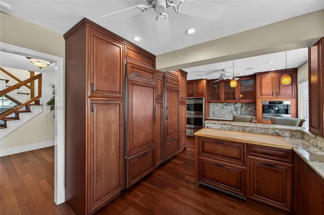 a bathroom with a granite countertop bathtub sink vanity and mirror