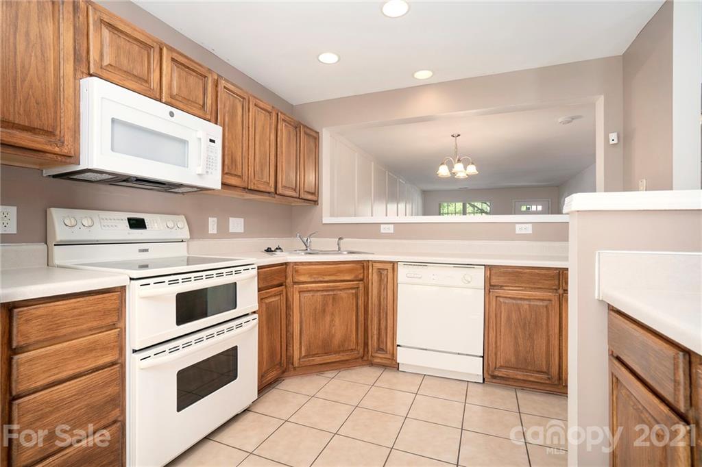 10621 Fuller Ridge Circle Charlotte, NC 28270 - Photo 2 of 32 a kitchen with granite countertop cabinets stainless steel appliances and a sink