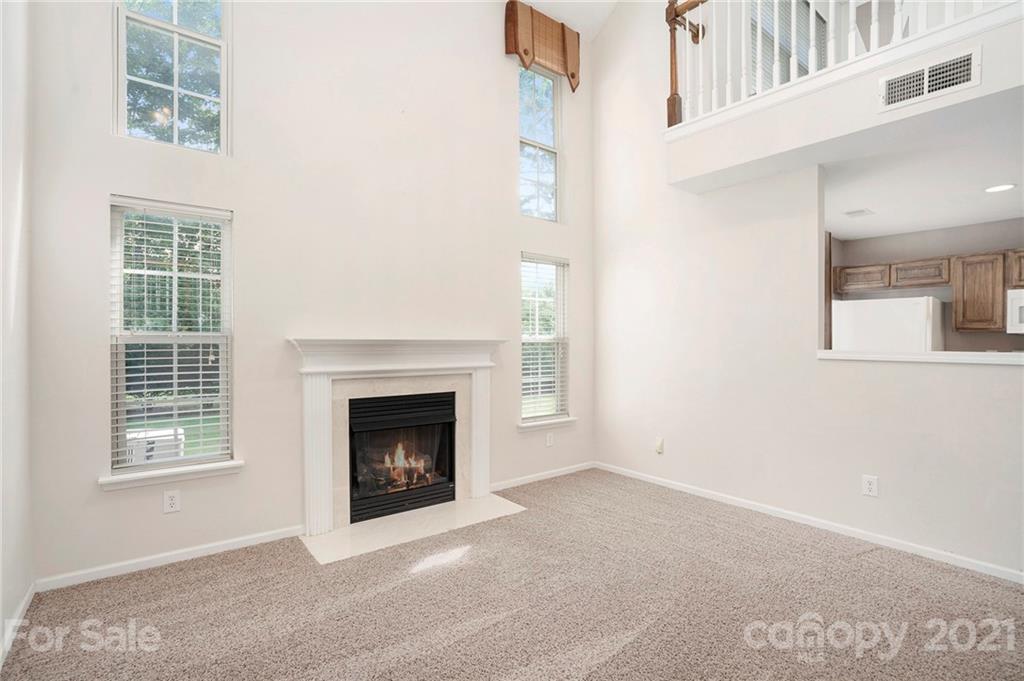 10621 Fuller Ridge Circle Charlotte, NC 28270 - Photo 11 of 32 an empty room with windows and fireplace