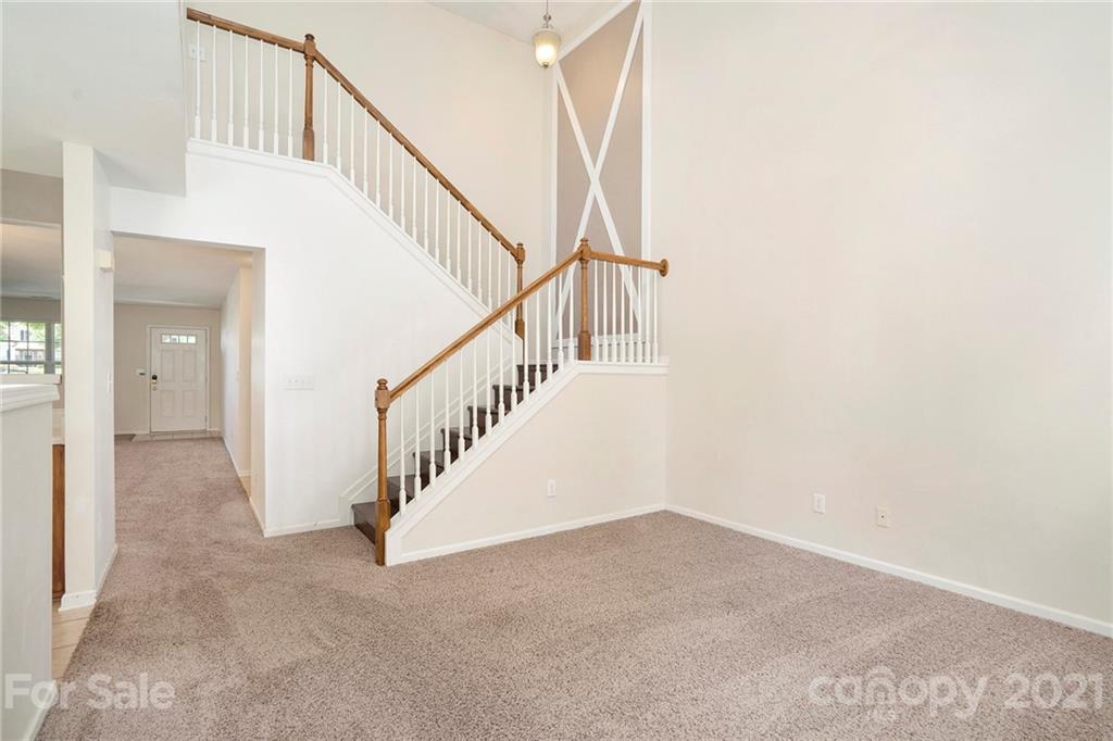 10621 Fuller Ridge Circle Charlotte, NC 28270 - Photo 13 of 32 a view of staircase with white walls and white walls
