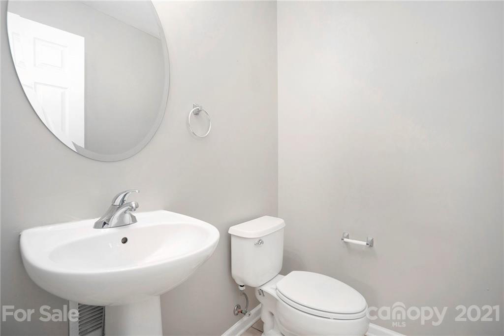 10621 Fuller Ridge Circle Charlotte, NC 28270 - Photo 14 of 32 a white toilet sitting next to a white sink