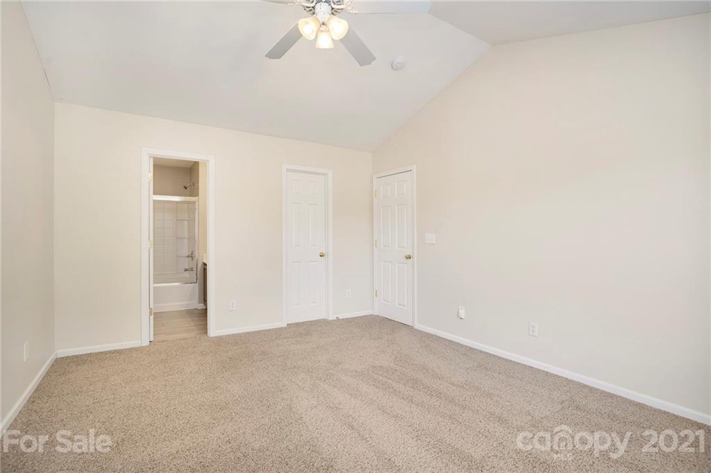 10621 Fuller Ridge Circle Charlotte, NC 28270 - Photo 24 of 32 a view of an empty room with a chandelier fan